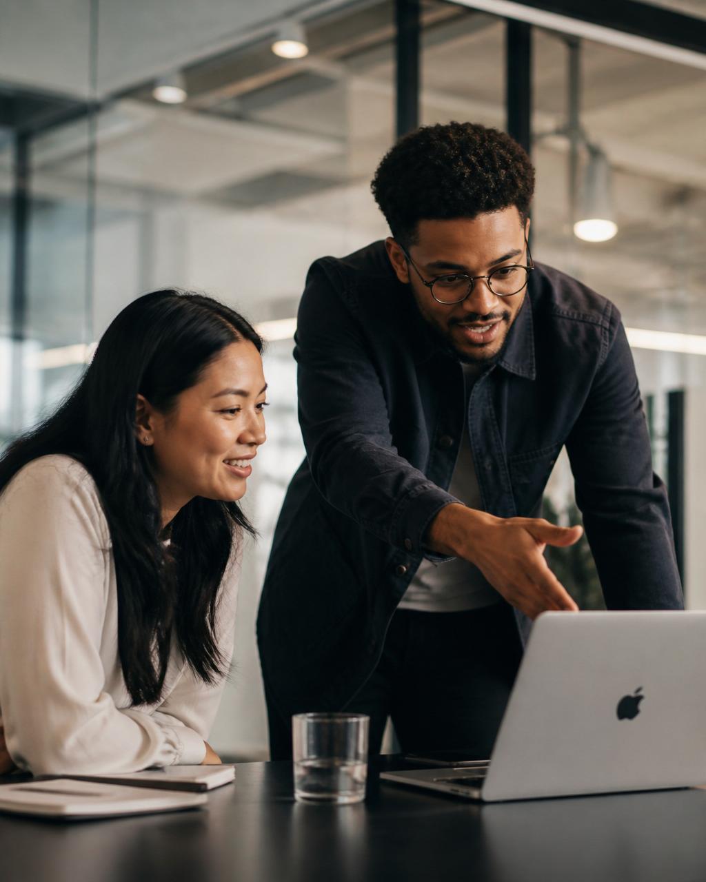 Two professionals having an energising coaching conversation in a modern office