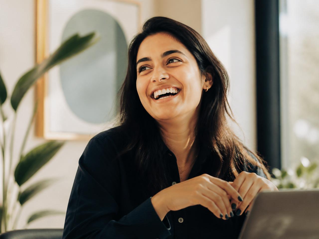 A confident professional laughing with genuine energy
